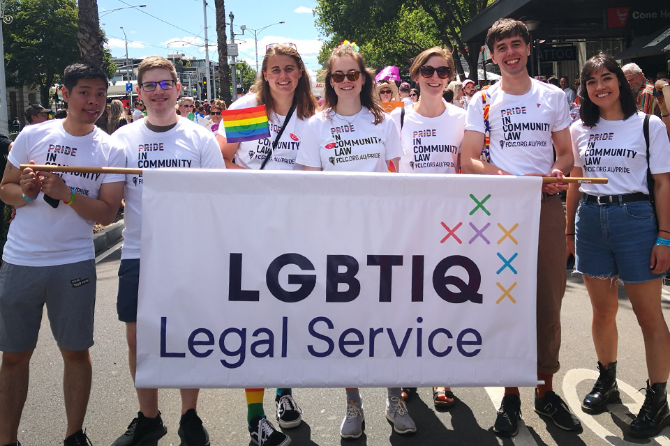 A photo of a group of young people holding a banner that reads "LGBTIQ Legal Service".