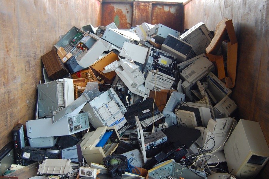 A photo of a pile of discarded computer equipment.