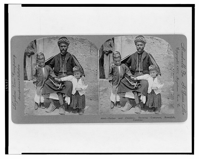 A stereographic image from Ramallah, Palestine, of a Palestinian father and his two children in traditional Palestinian dress, ca. 1905. Source: Keystone View Company.