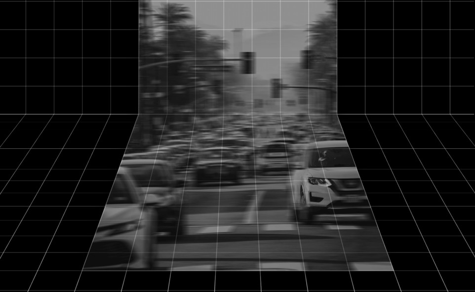 A blurred black and white image of car traffic, on a black grid