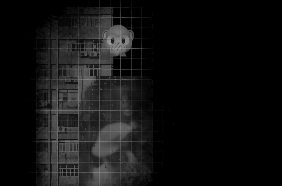 darkened image of an apartment building with a monkey emoji over top