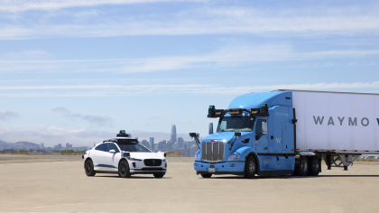 The 5th-generation Waymo Driver on both a white, Jaguar I-PACE and Blue Waymo Via Class 8 Truck 
