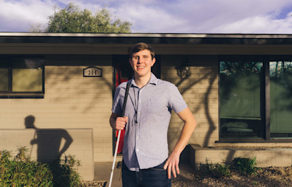 Max outside in front of his house
