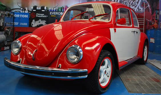 Restored Red Volkswagen Beetle in Auto Shop