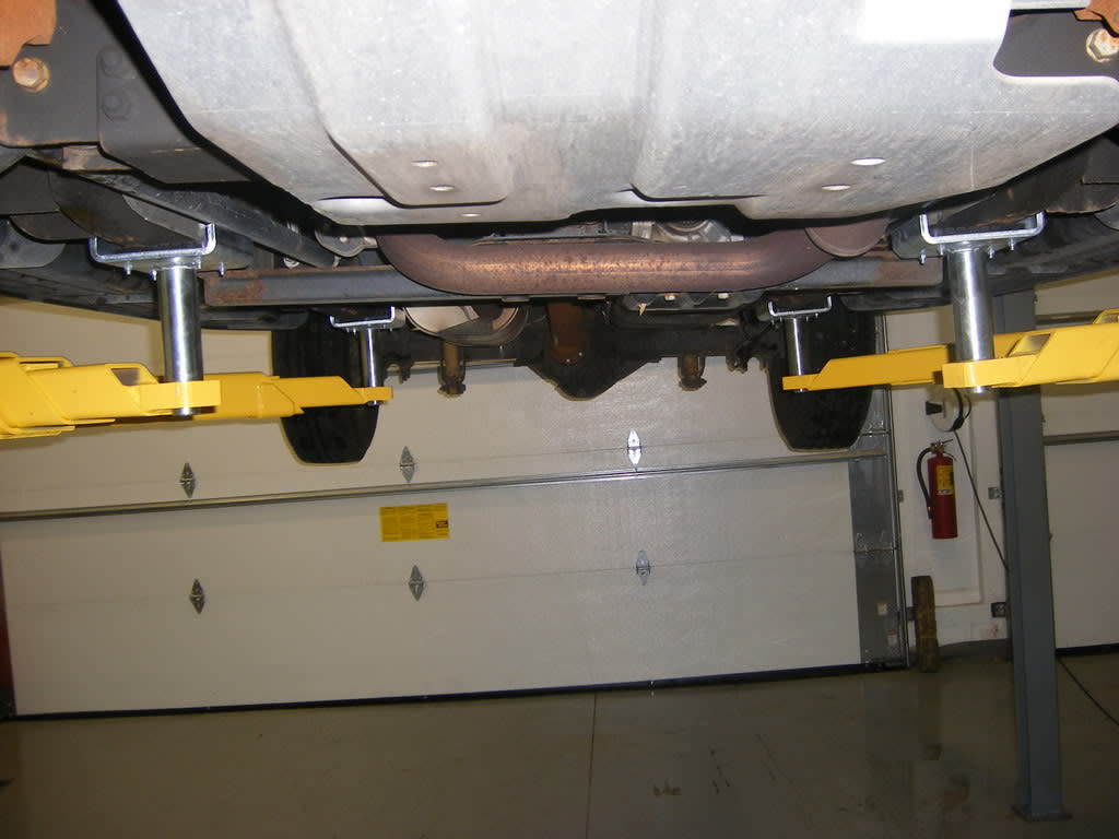 Four Lift Cradles Supporting Vehicle From Frame Points