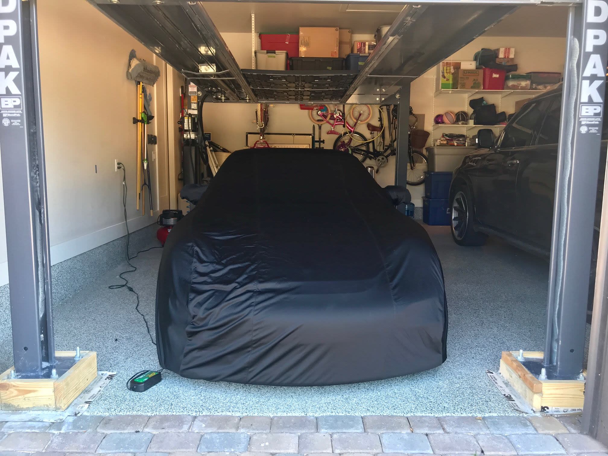 BendPak Four Post Lift in Home Garage With Covered Car Storage