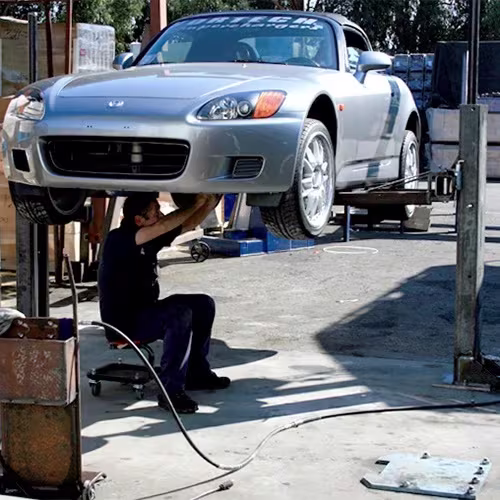 working-under-original-maxjax-two-post-lift-prototype