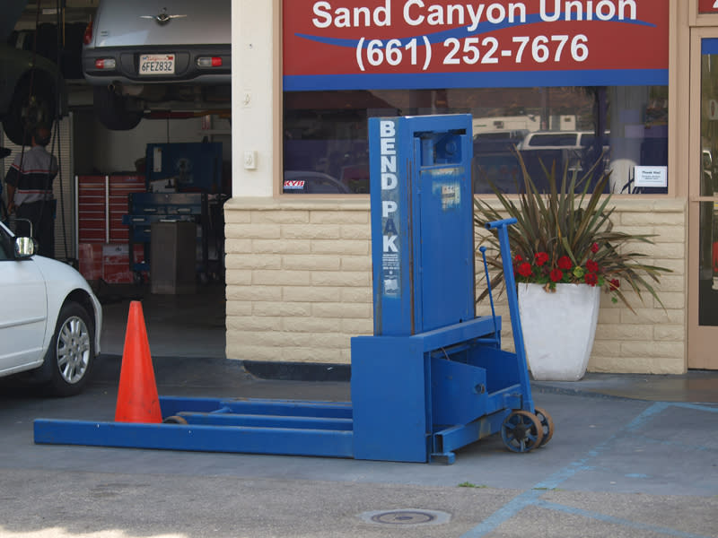Portable BendPak Car Lift At Auto Service Shop Entrance