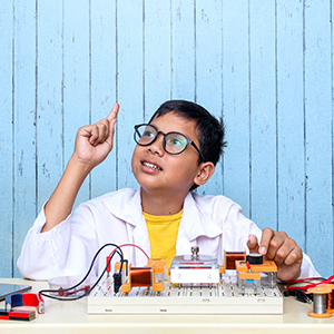 Student conducting a hands-on electrical circuit experiment for a STEM project.