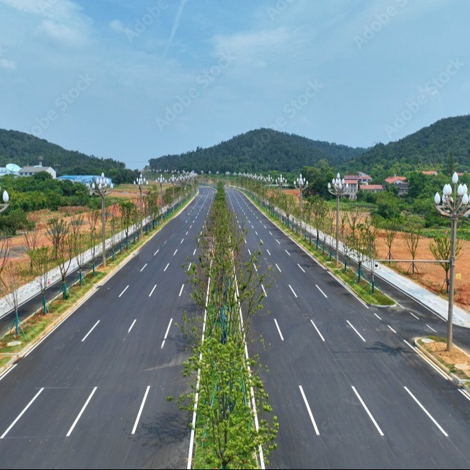 A divided highway with separate lanes for opposing traffic, designed to improve safety and support efficient travel between destinations.