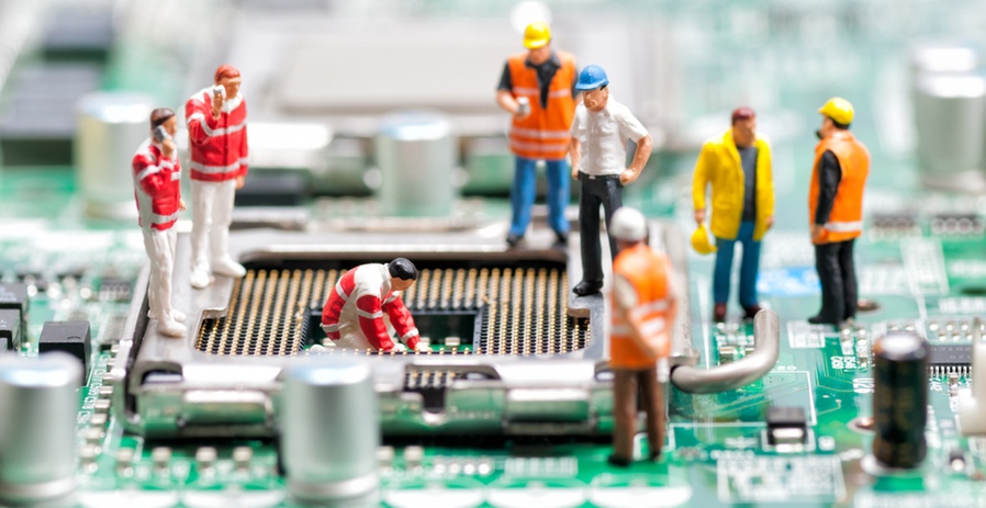 <html><head></head><body><p>Miniature models of people working on a circuit board</p></body></html>