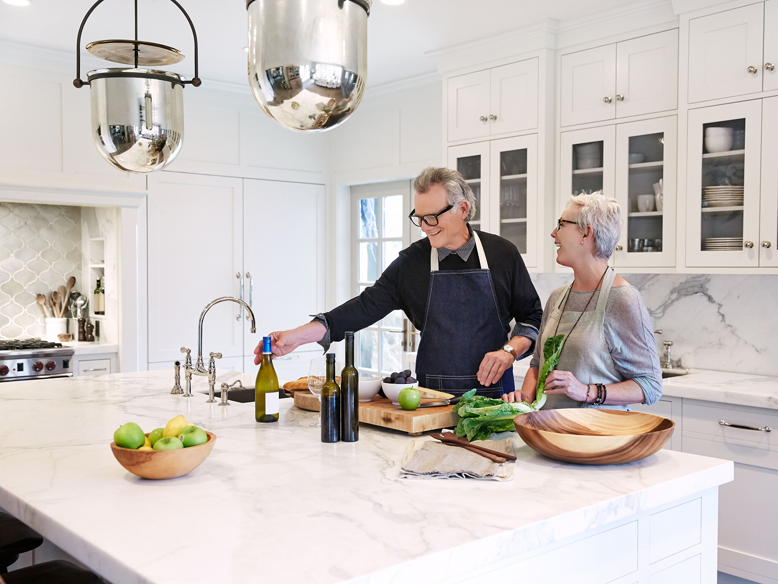 Husband and wife cook together in their newly remodeled kitchen