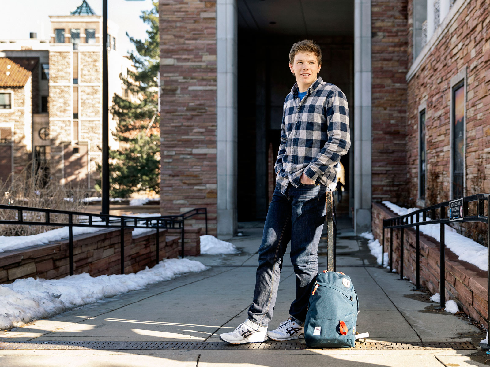 College student standing with backpack on campus