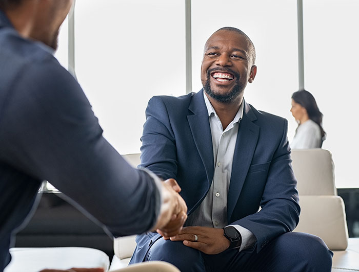 Two men shake hands indicating that a business deal has been completed
