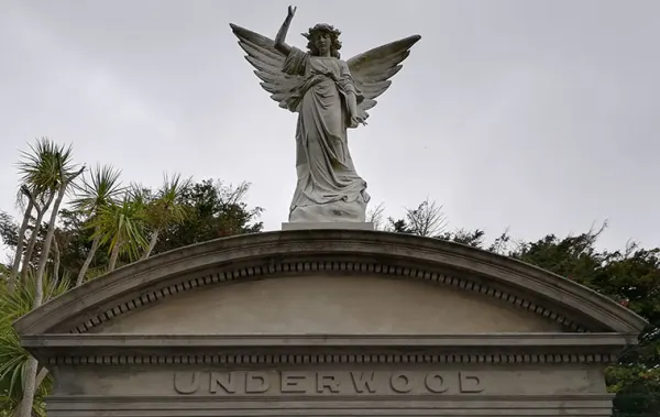 A statue of an angel sits atop a memorial