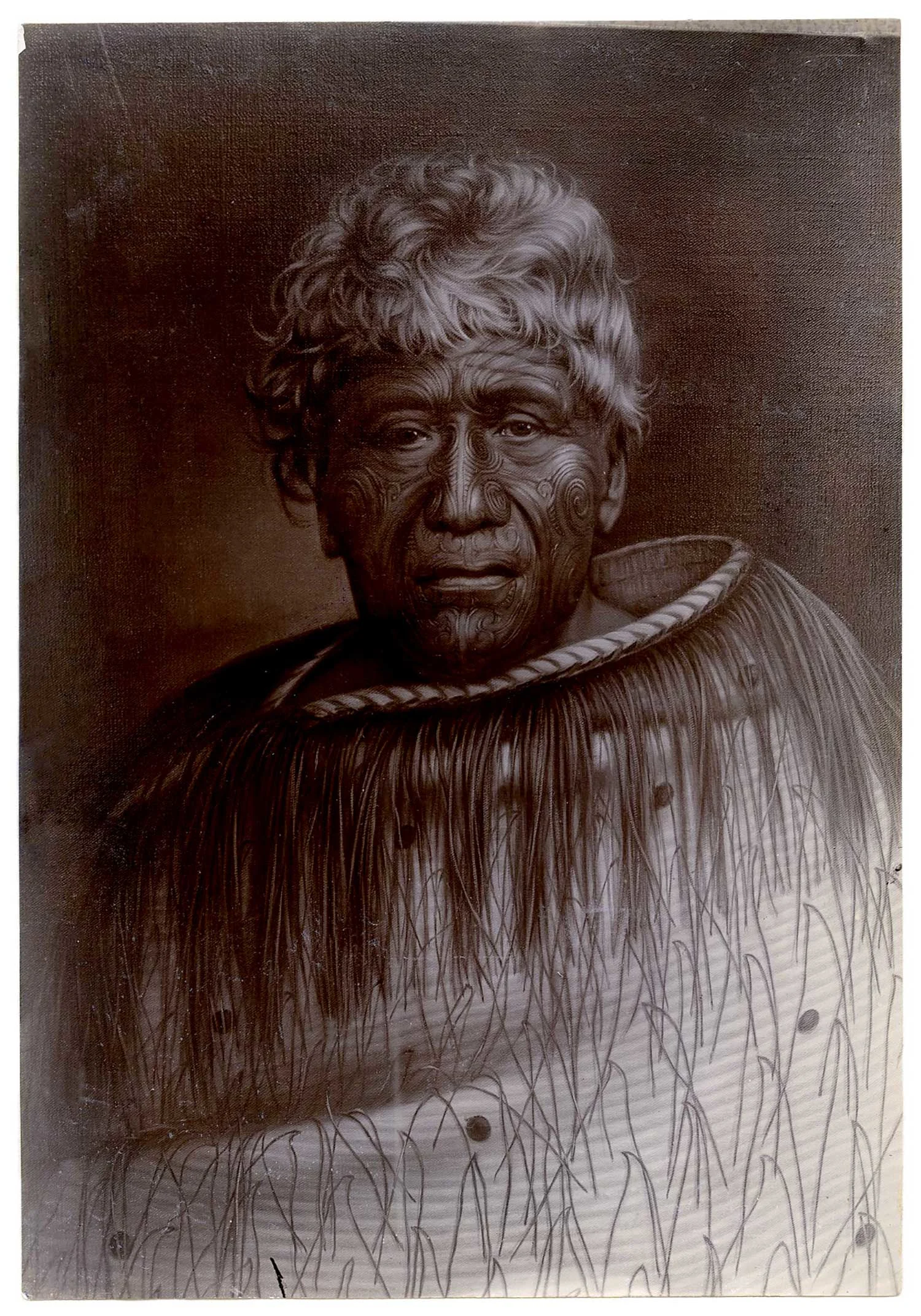 A portrait of a Māori leader a traditional Māori tattoo on his face, short white hair and wearing a cloak
