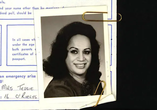 Passport photo of Carmen Rupe attached to application file.