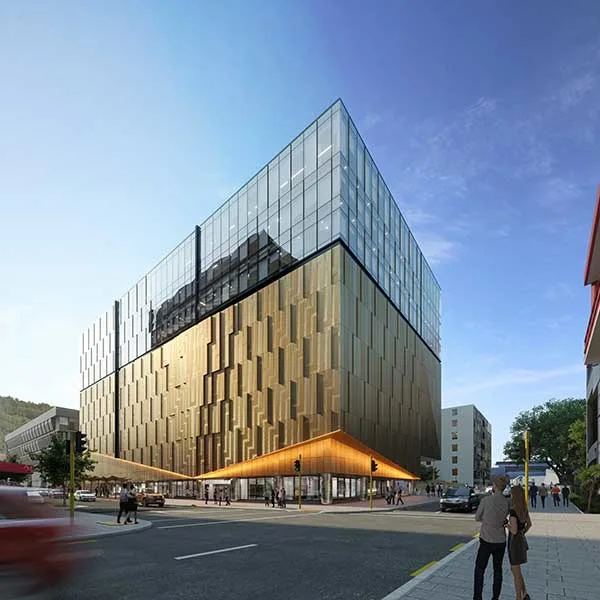A couple looking at a new building with glass exterior on a background of clear blue sky.