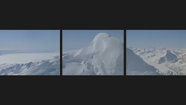 A still from 'This is New Zealand'. Snowy white mountains and a clear blue sky stretch out into the horizon.
