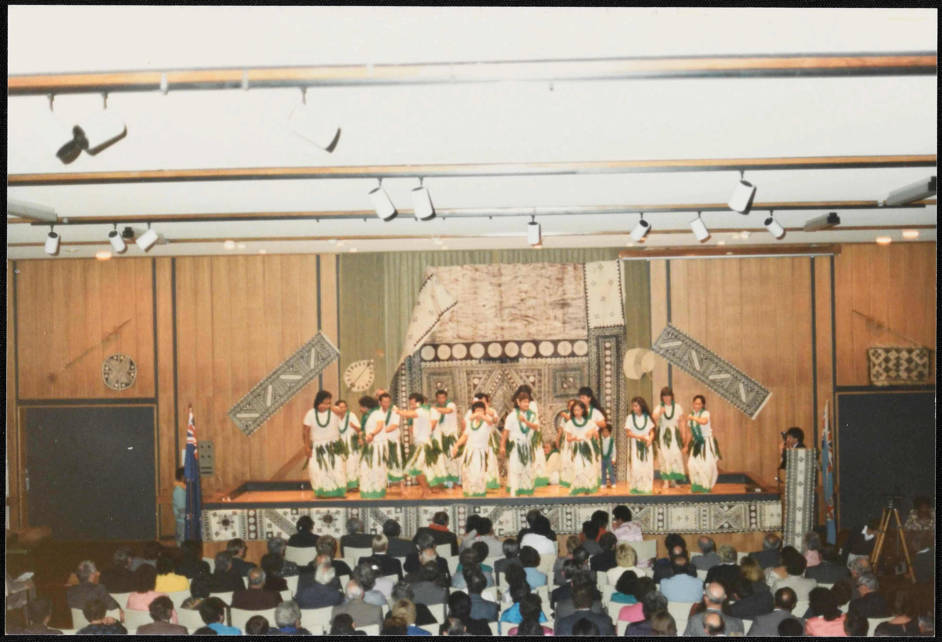 Image: A group of people in traditional Rotuman dress stand on a stage before a large audience.