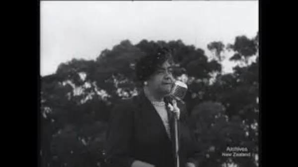 Black and white photo of a man wearing a black jacket with trees in the background