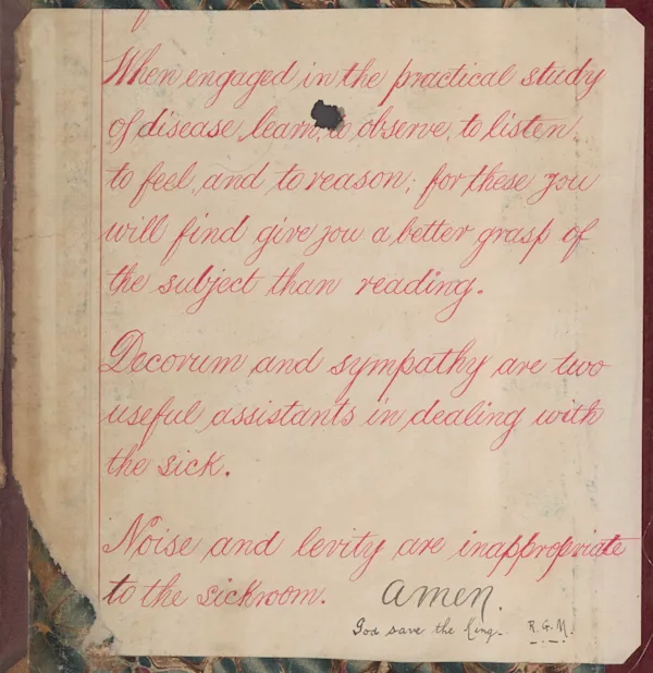 A handwritten note written in red ink pasted on an old book cover