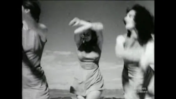 A still from 'Weekly Review No. 346'. 3 women raise their arms in the air while performing rhythmical gymnastics.