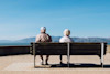 A senior couple sitting on a park bench. A senior couple sitting on a park bench.
