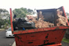 A red skip bin full of waste in Auckland. A red skip bin full of waste in Auckland.