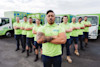 Junk Run waste removal team standing in front of trucks. Junk Run waste removal team standing in front of trucks.