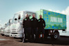 Three Junk Run waste removal team members standing in front of truck fleet. Three Junk Run waste removal team members standing in front of truck fleet.