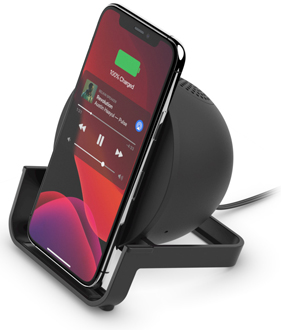 Angled view of a Phone sitting on a Black Belkin Wireless Charging Stand with Speaker