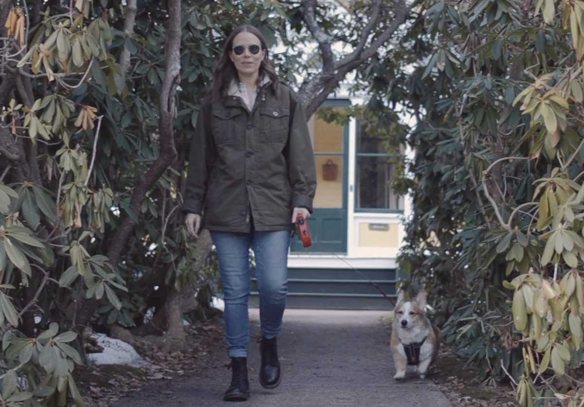 Jules walking with their dog, Lucius.