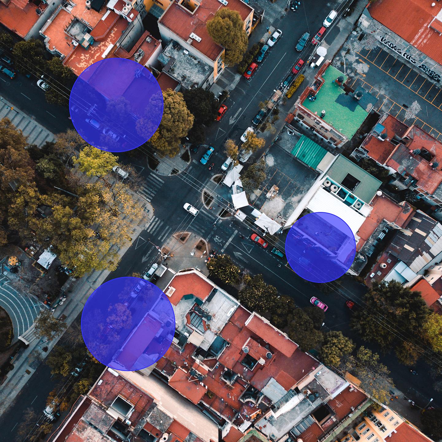 Image of an aerial view of an intersection with blue 50% transparent circles (geofences) overlayed on it.