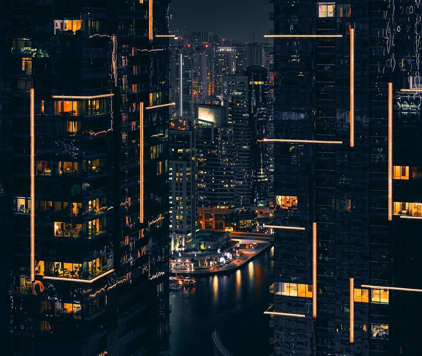 buildings at night lit up in a yellow light