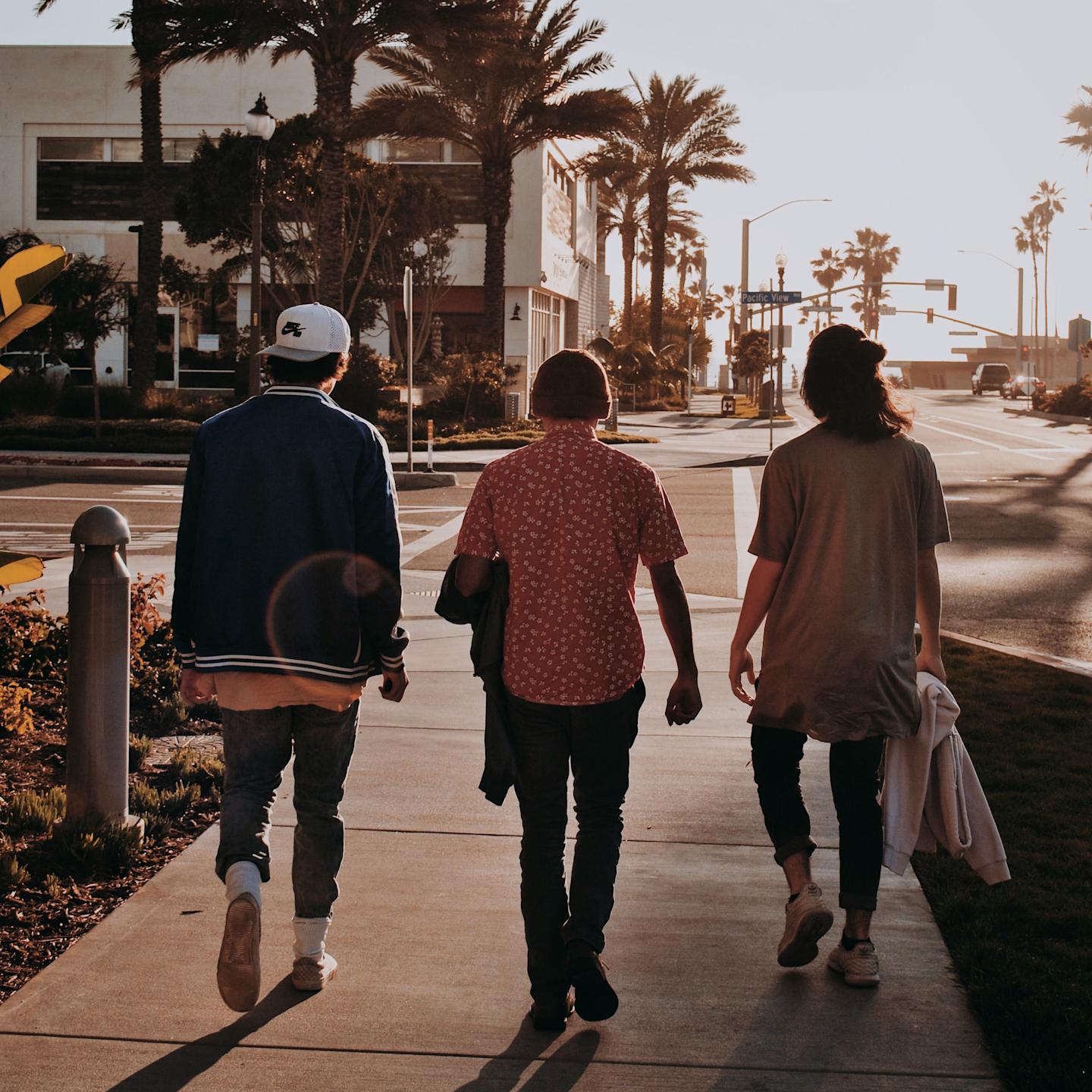 three men walking down the road