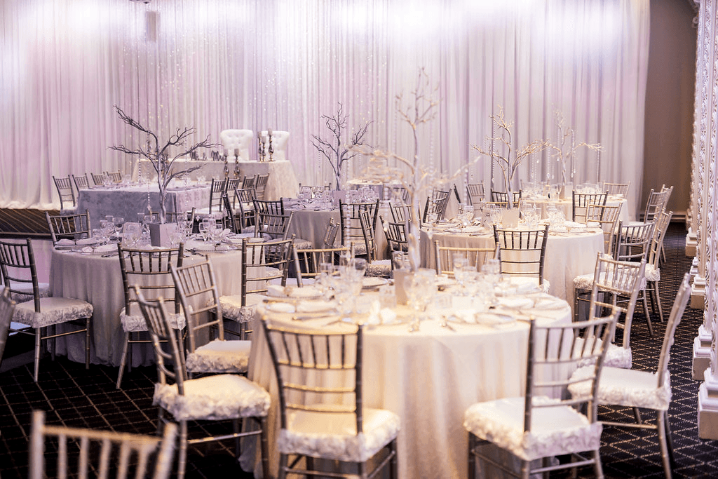 Table seating with white and gold accents at the Queen Anne venue at Paradise Banquet Halls.