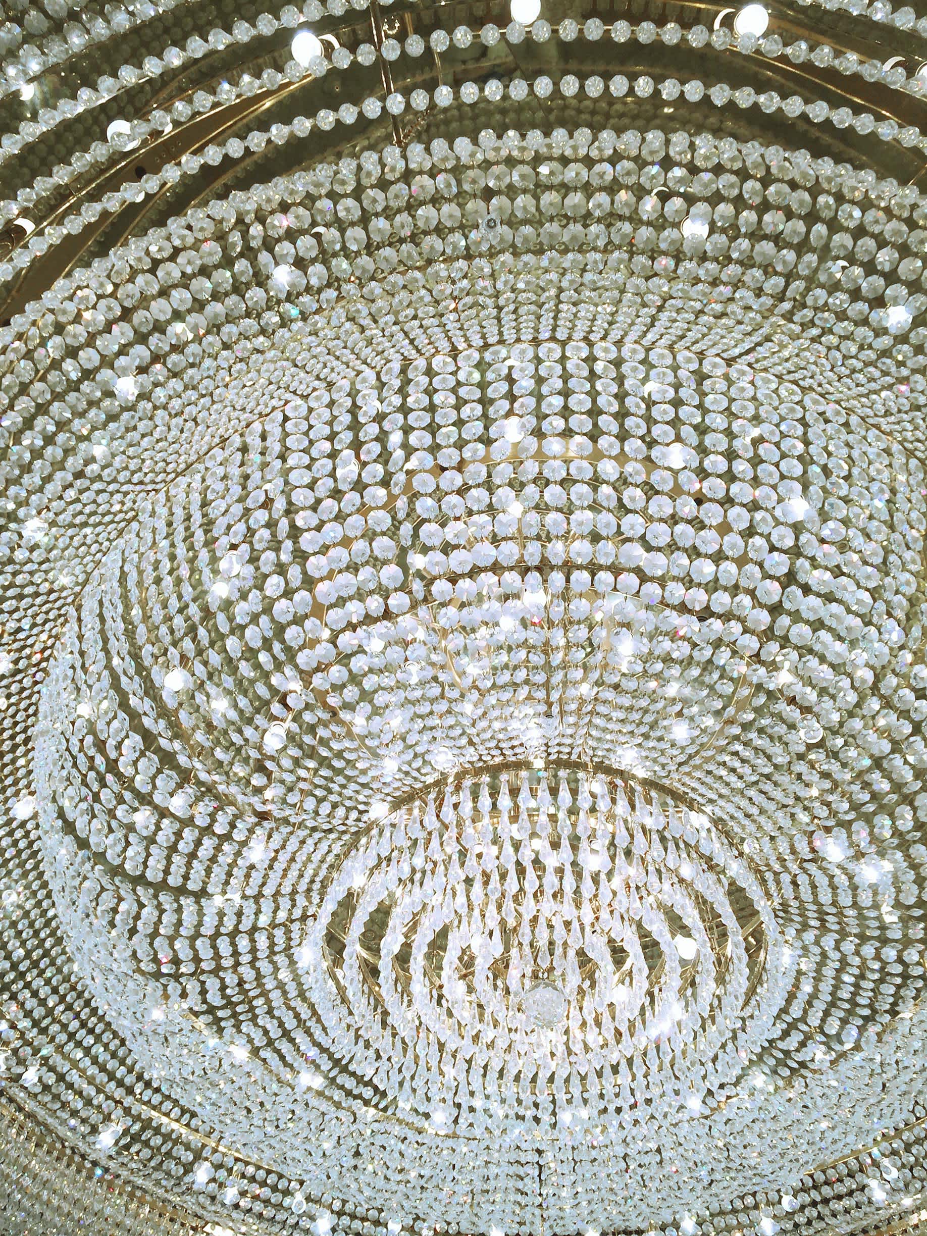 A close-up shot of a crystal chandelier from below.