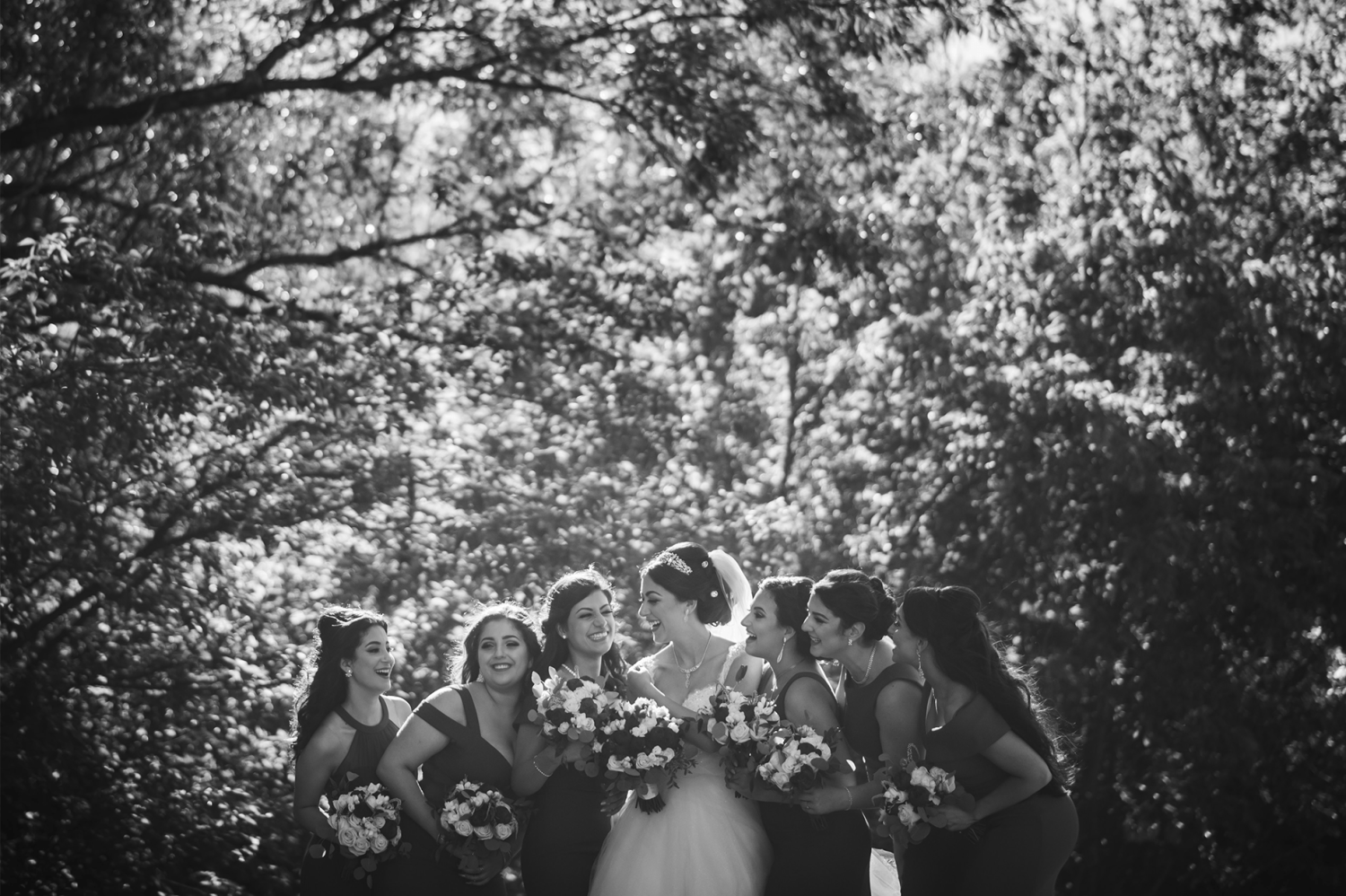A bride and their bridesmaids grouped together outside in the Paradise Banquet Halls Garden venues.
