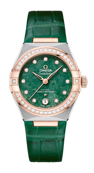 An Omega Constellation watch with a green alligator leather strap. The bezel is studded with diamonds, and the green marbled dial features gold hands and diamond hour markers. The case is a combination of stainless steel and gold.