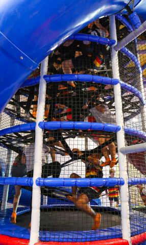 Kids climbing a playground tower