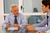 Two business men talking at desk