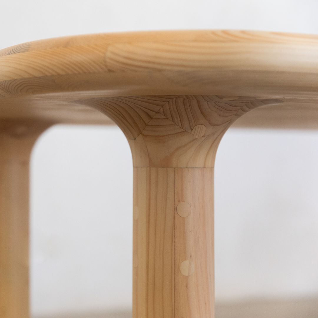 A close up of the table where the leg joins the table top illustrating the smooth and rounded lines