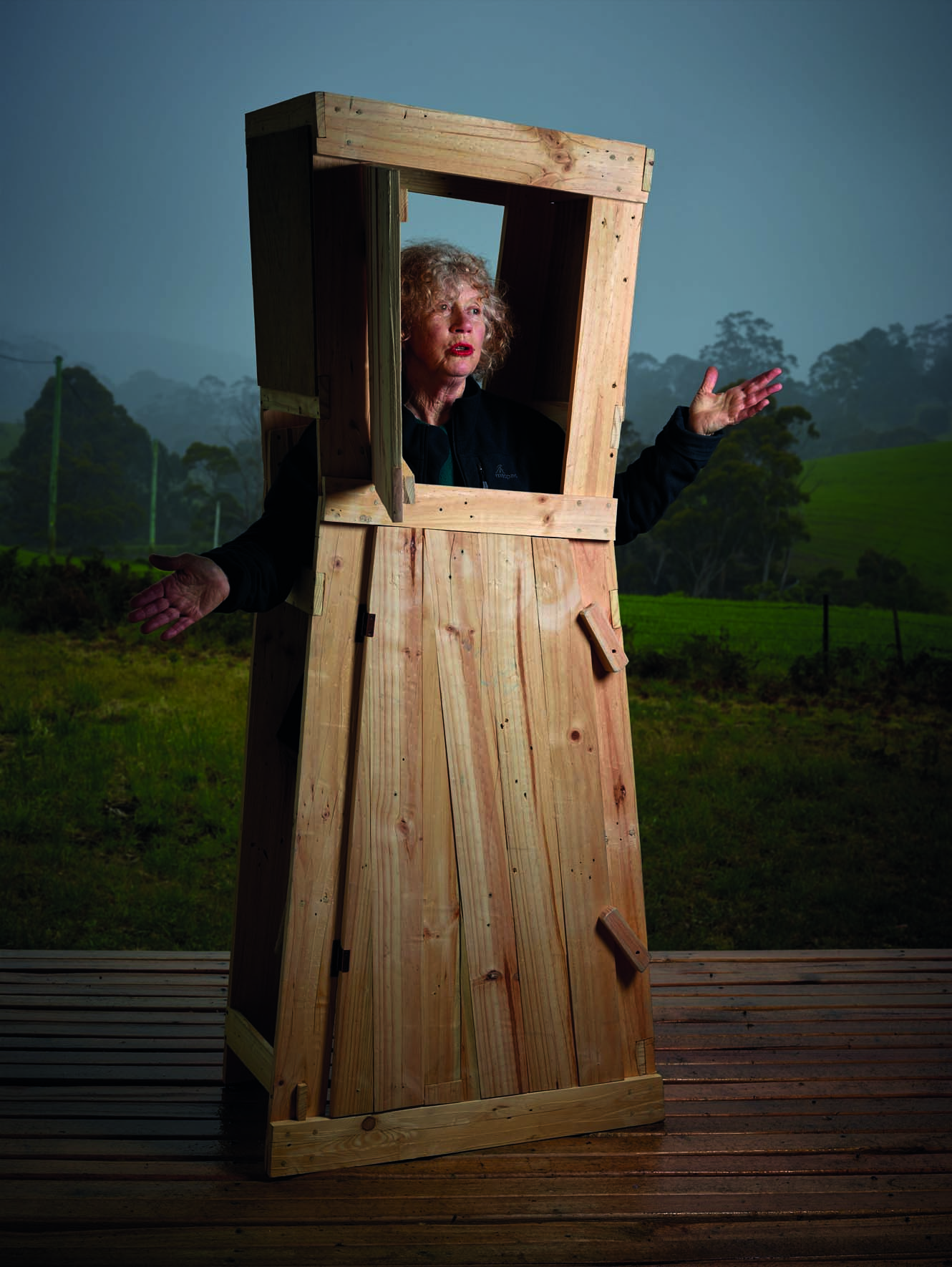 An image of Gay Hawkes sitting in a wooden chair