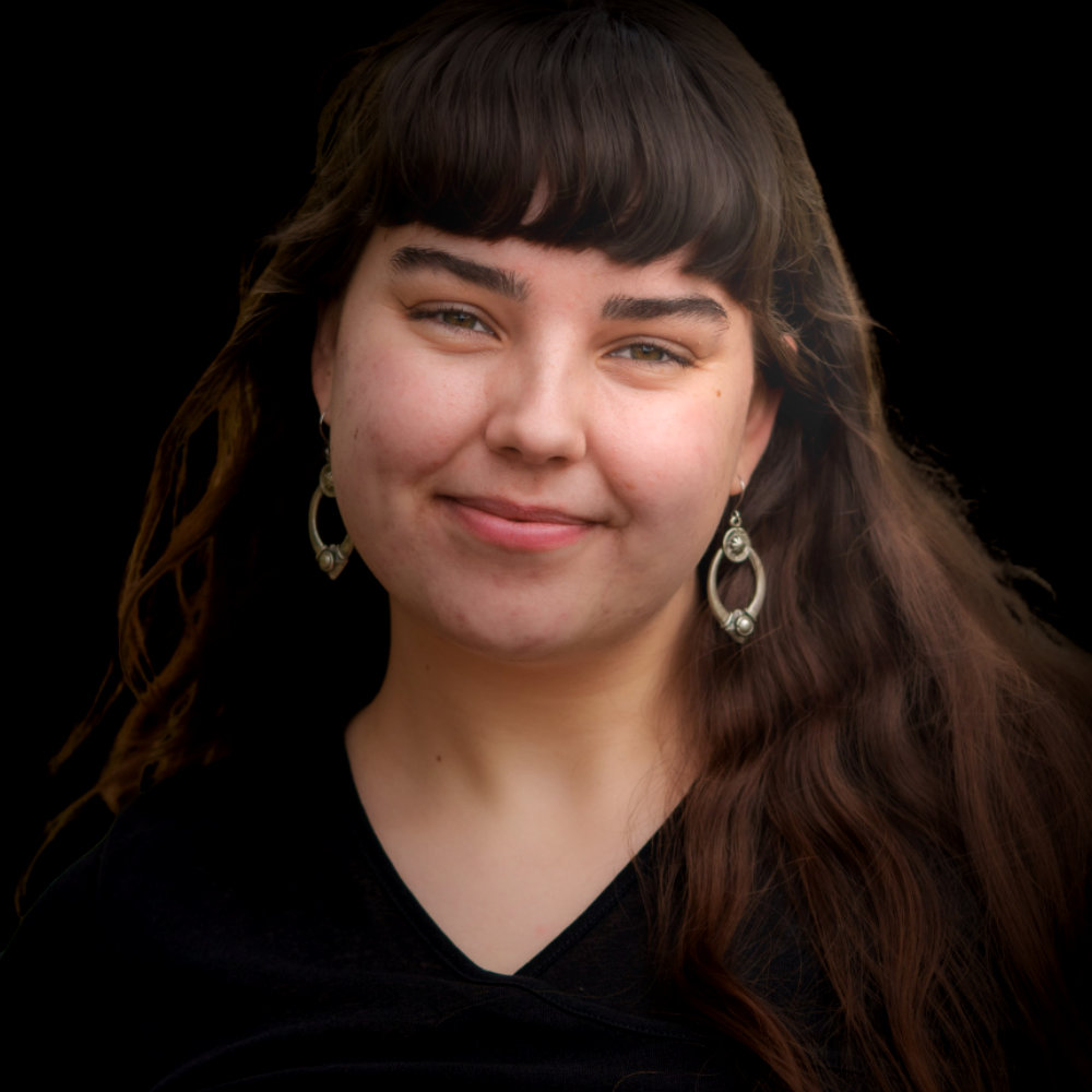 A woman with long brown hair smiling into the camera