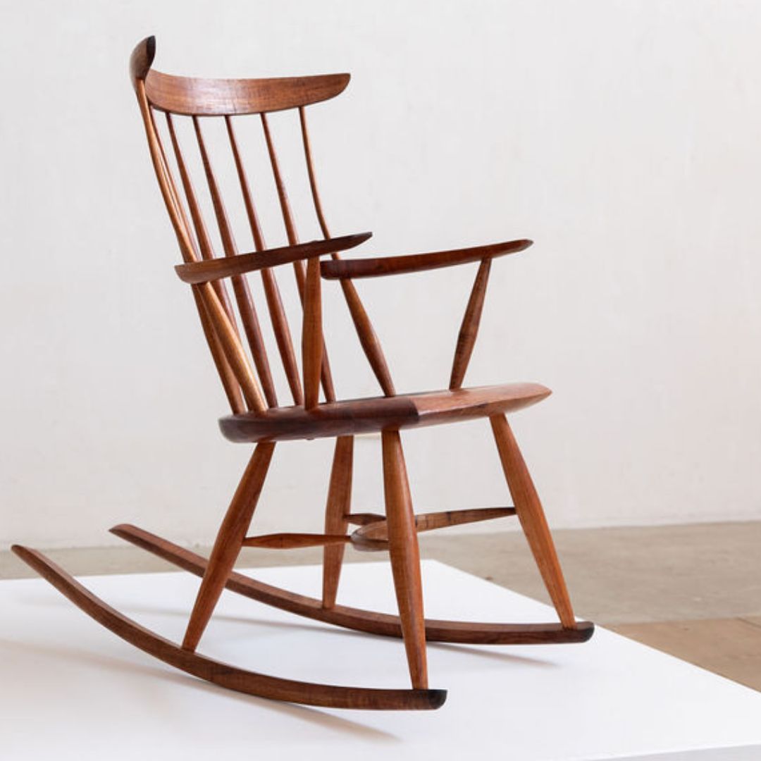 A timber rocking chair on a plinth
