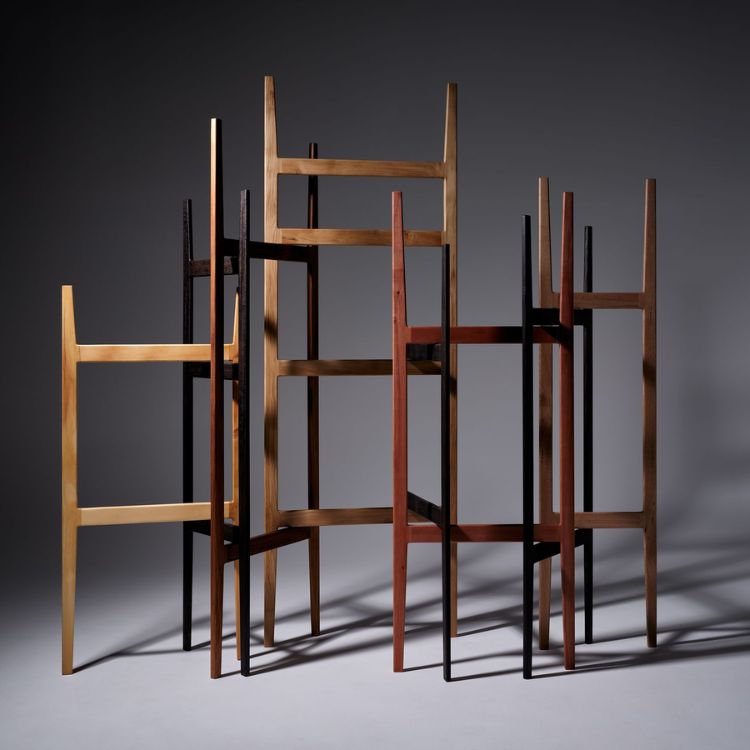A series of interlocking frames made from different woods forming a complex stand
