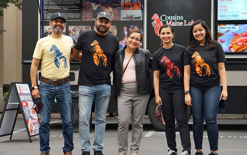 A photo of our SF Bay Area family standing dressed in CML gear in front of their food truck.