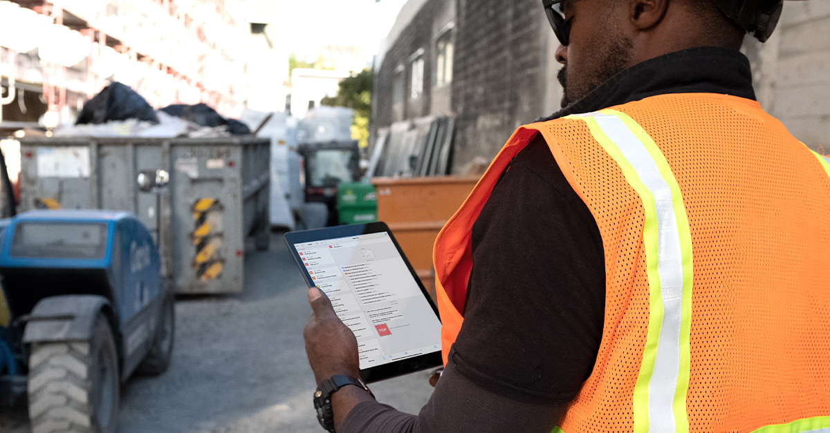 Construction worker using Fieldwire on his tablet to receive his tasks for the day and document work completed.