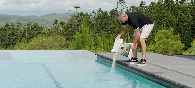 mineral swim being poured to the saltwater pool